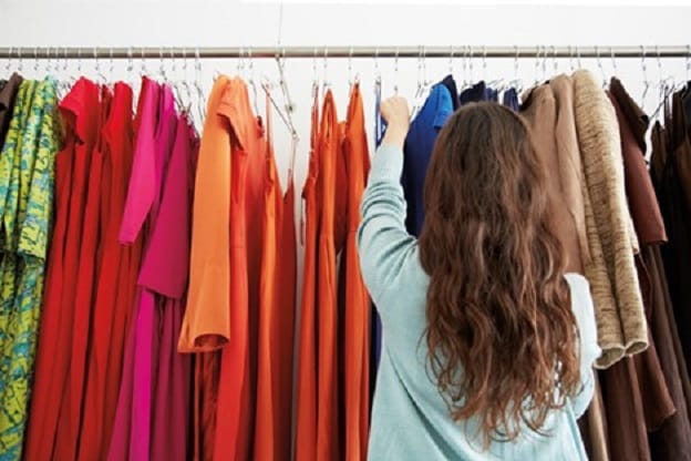 Woman looks at colorful luxury garments